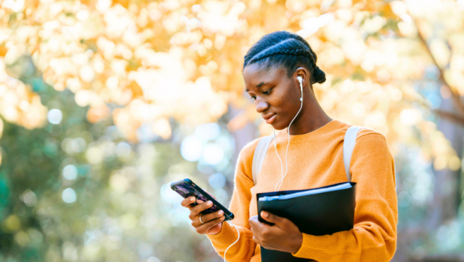 young person on campus with headphones