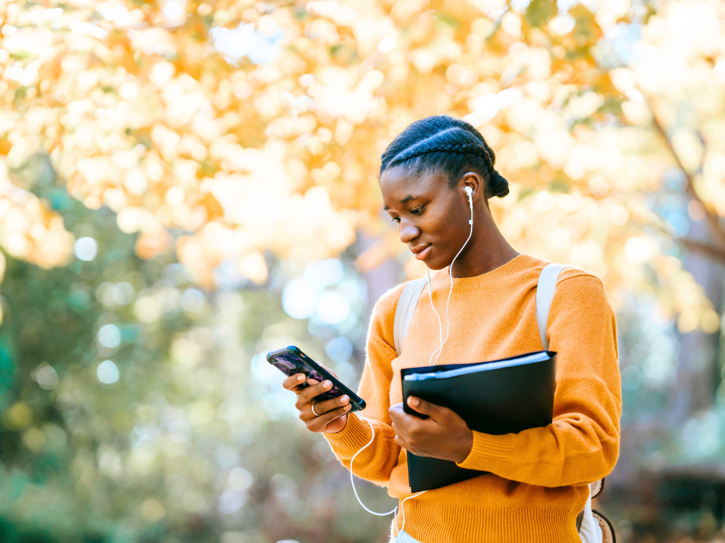 young person on campus with headphones