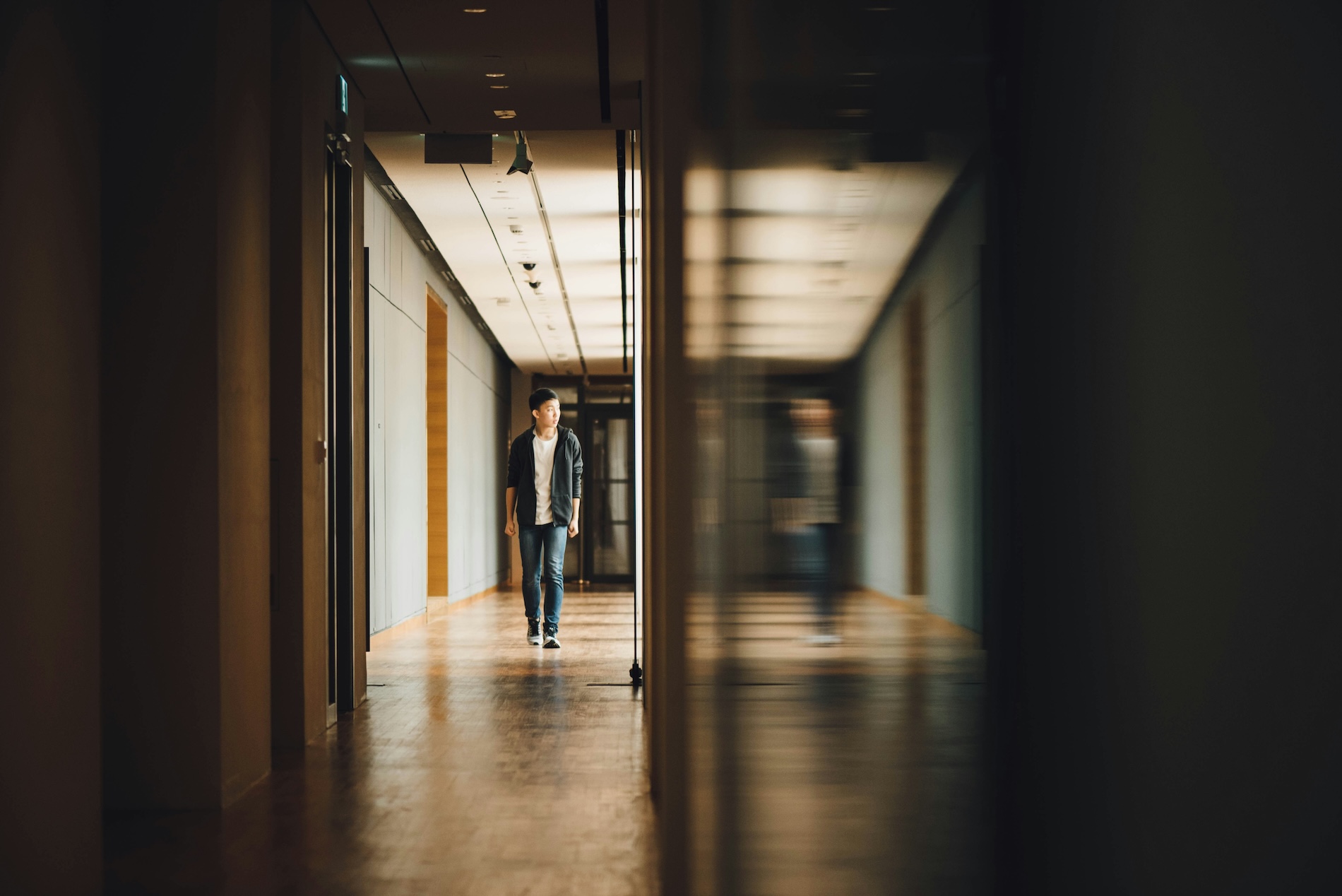 A student walks through an empty hallway