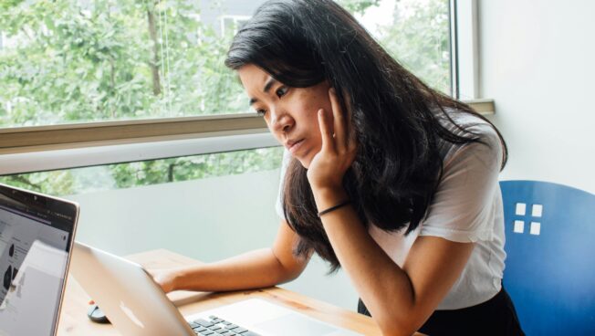 Young woman concentrating on her laptop screen