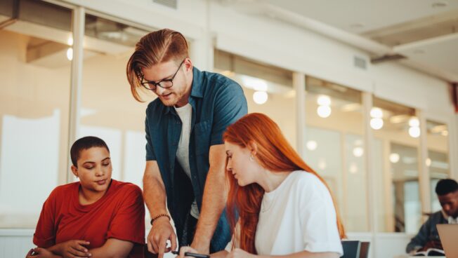 Professor helping students with selecting their electives