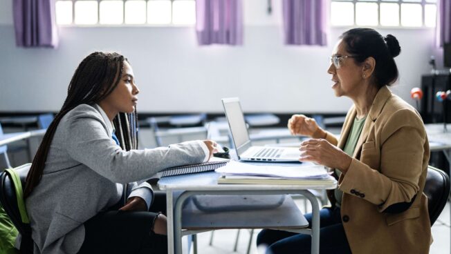 Student discussing grades with professor